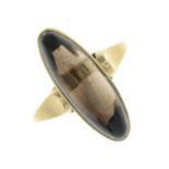 A smoky quartz cabochon single-stone ring.Approximate dimensions of smoky quartz 11.8 by 7.2 by