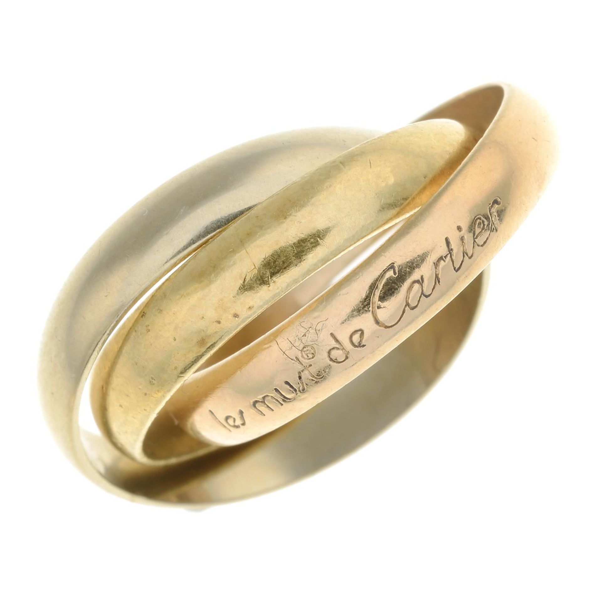 A 'Les Must de Cartier Trinity' ring, by Cartier.Makers marks for Cartier.Stamped 750.Ring size L.