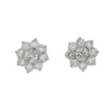 A pair of diamond floral cluster earrings.Estimated total diamond weight 1ct,