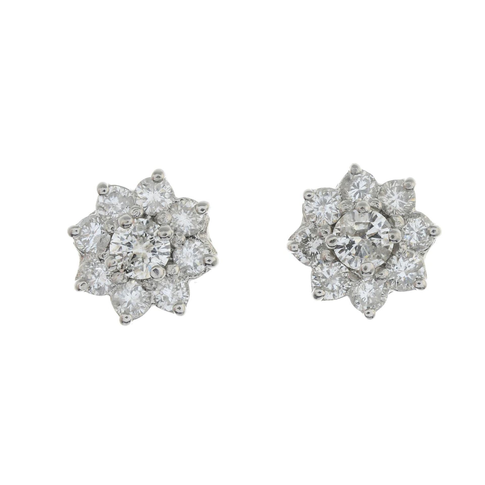 A pair of diamond floral cluster earrings.Estimated total diamond weight 1ct,