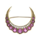 A late 19th century gold ruby and diamond crescent brooch.Estimated total diamond weight