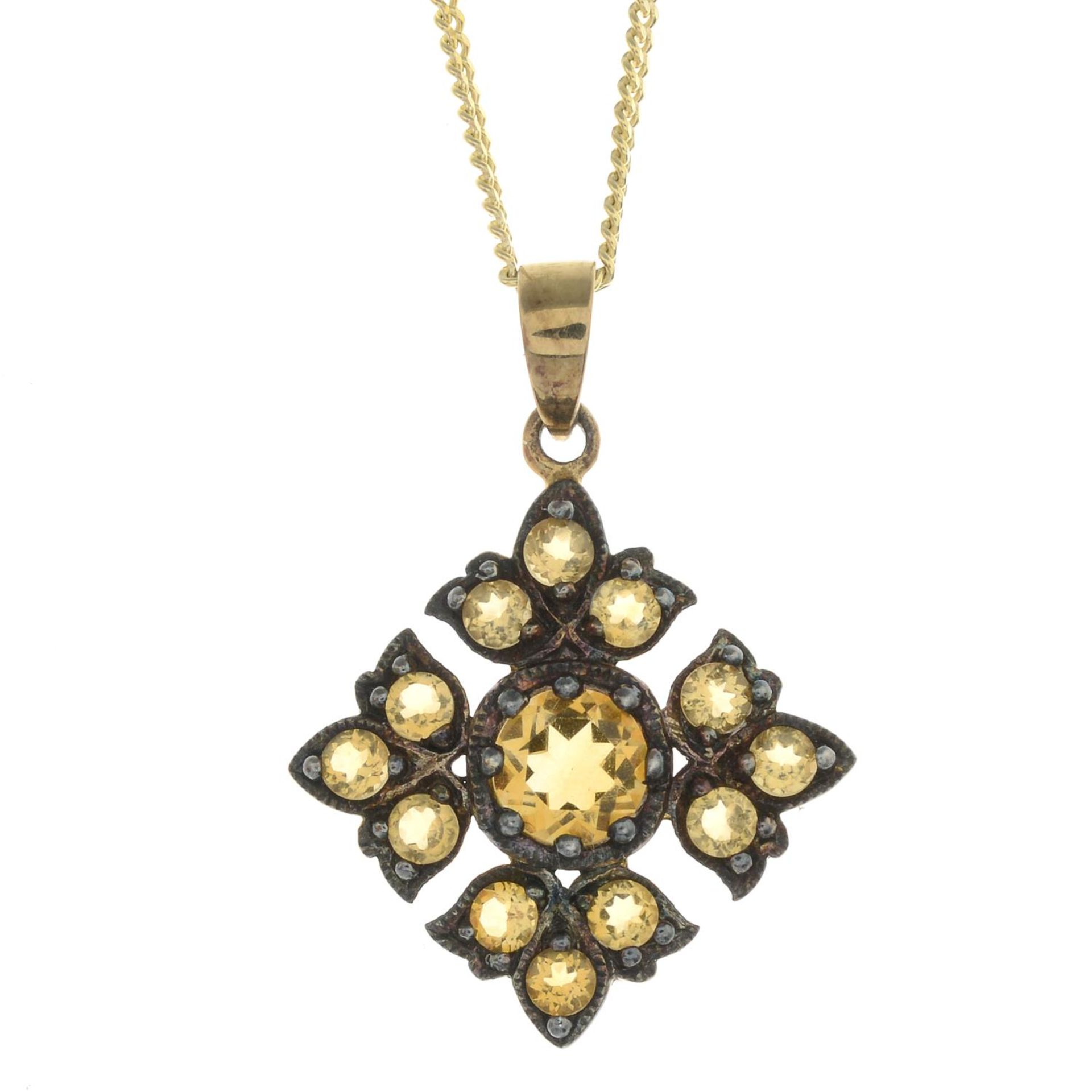 A citrine quatrefoil pendant, with 9ct gold chain.Chain with hallmarks for 9ct gold.