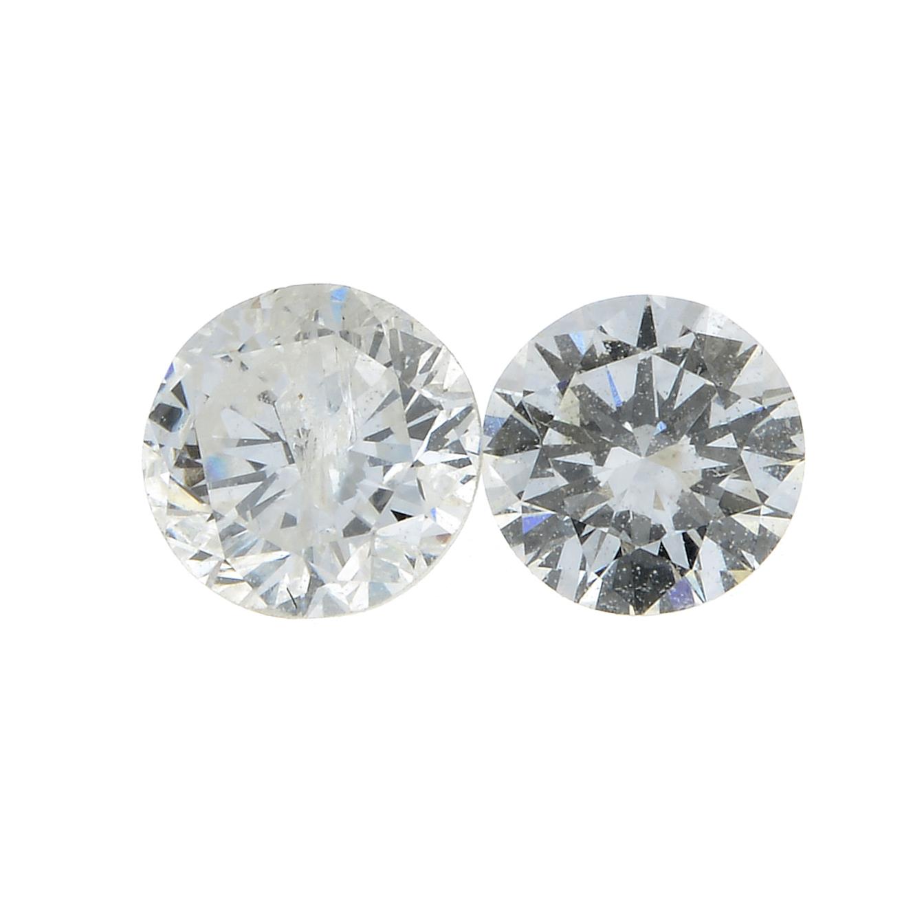 Two brilliant cut diamonds.