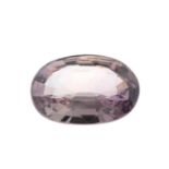 An oval-shape brownish orange sapphire.