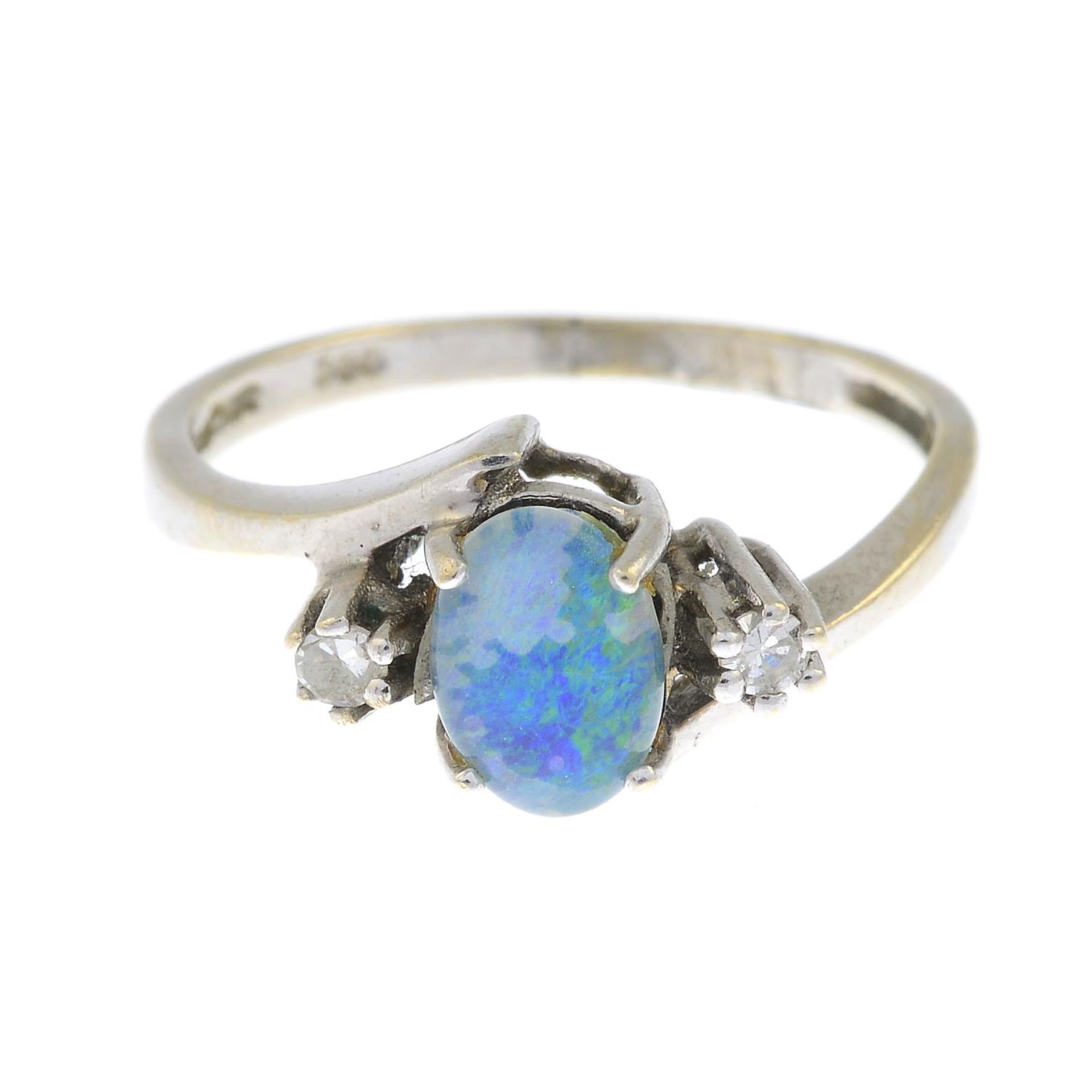 An opal triplet and diamond three-stone ring.Estimated total diamond weight 0.10ct.