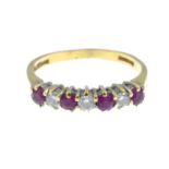 An 18ct gold ruby and diamond seven-stone ring.Total diamond weight 0.20ct, stamped to band.