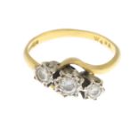 An 18ct gold diamond three-stone ring.Estimated total diamond weight 0.30ct,