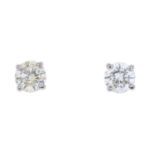 A pair of diamond stud earrings.Estimated total diamond weight 0.95ct, J-L colour, SI2-P1 clarity.