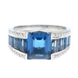 A blue topaz and diamond ring.Estimated total diamond weight 0.15ct.Stamped 750.Ring size O.