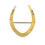 A bi-colour horseshoe brooch.Stamped 18CT.