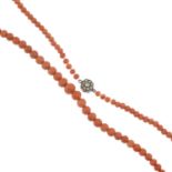 A graduated coral single-strand necklace, with paste push-piece clasp.Length 53cms.