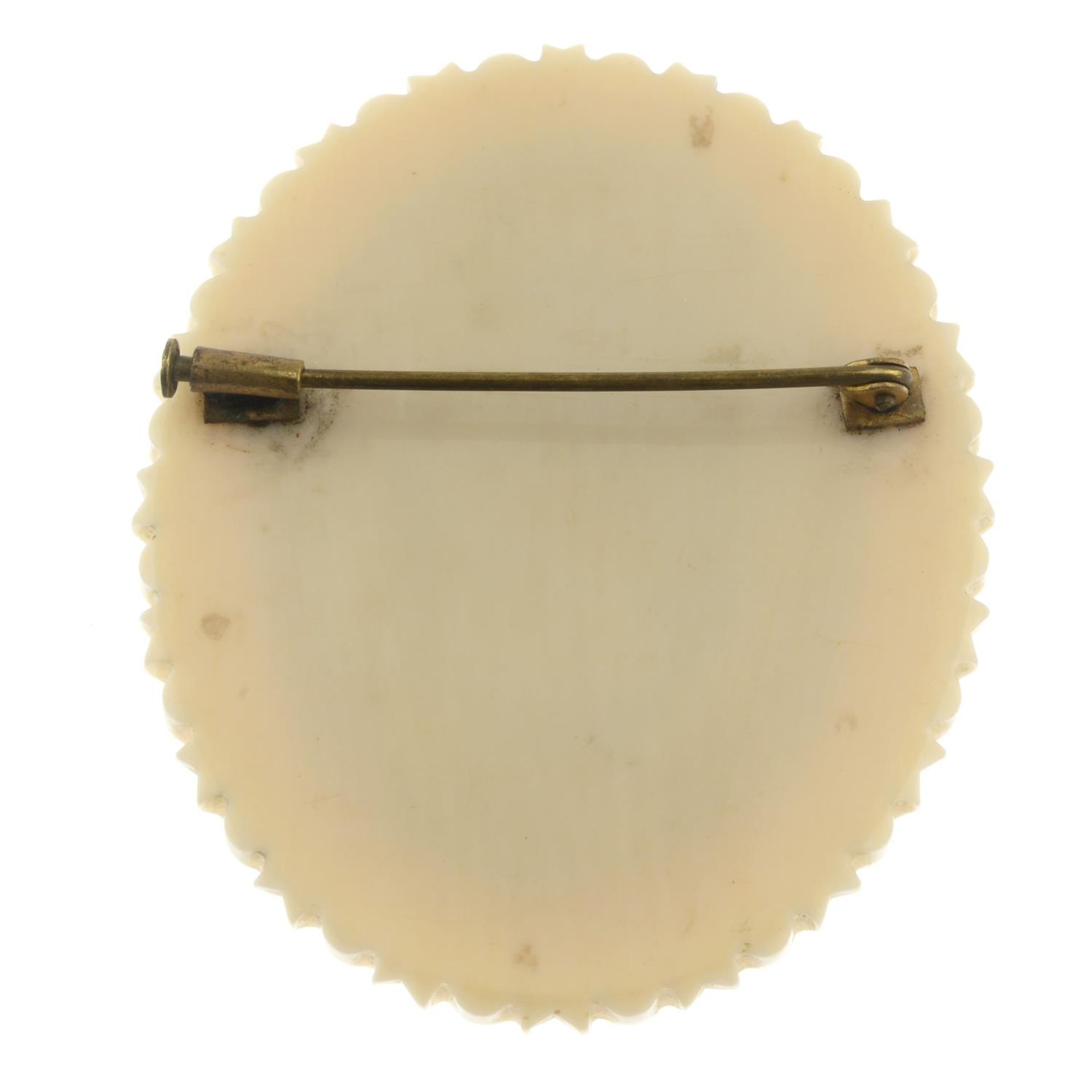 A late 19th century painted ivory brooch.Length 5.9cms. - Image 2 of 2