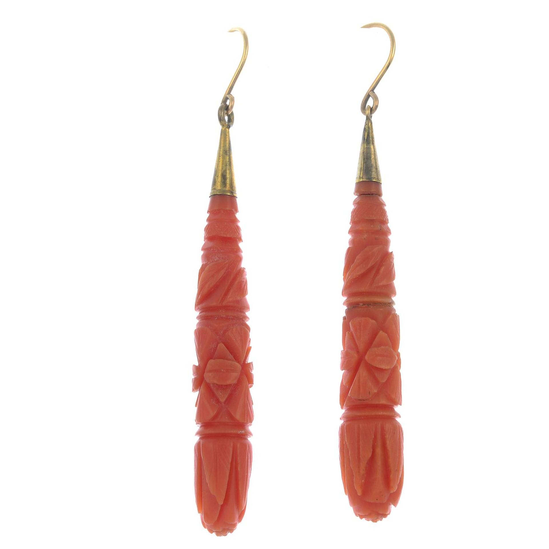 A pair of late 19th century gold carved coral earrings.Coral untested.Length 6.6cms.