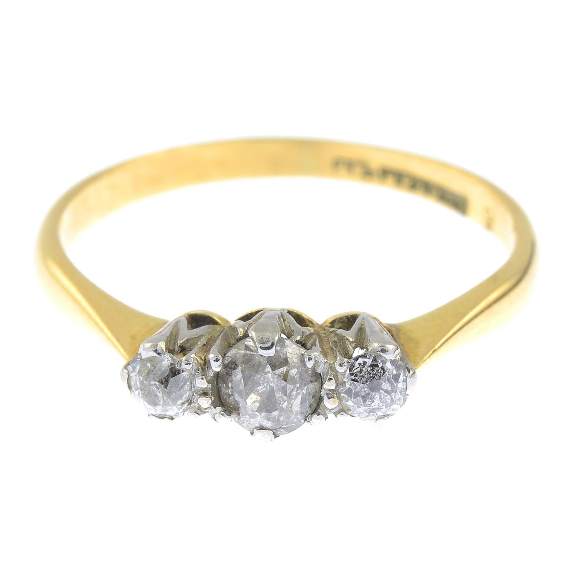 An old-cut diamond three-stone ring.Estimated total diamond weight 0.35ct.Stamped 18ct & PLAT.Ring