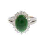 A jade cabochon and single-cut diamond cluster ring.Estimated total diamond weight 0.40ct.Stamped