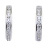 A pair of 18ct gold diamond hoop earrings.Estimated total diamond weight 0.35ct.