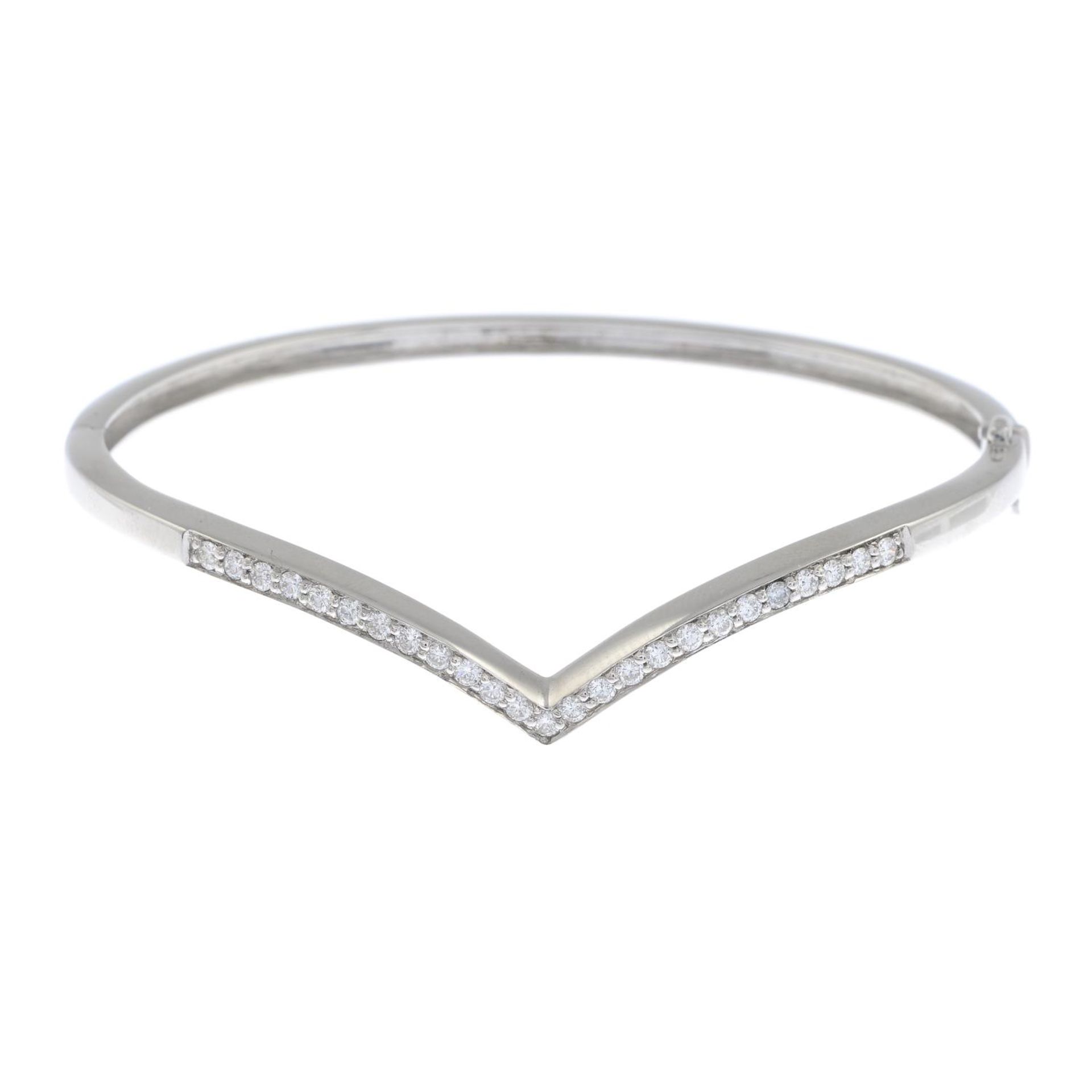 A diamond chevron bangle.Estimated total diamond weight 0.50ct.