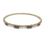 A sapphire and diamond bangle.Estimated total diamond weight 0.15ct.