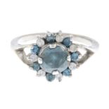 A colour-treated blue diamond and diamond cluster ring.Principal colour-treated blue diamond