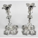 A pair of George II cast silver candlesticks by John Cafe,