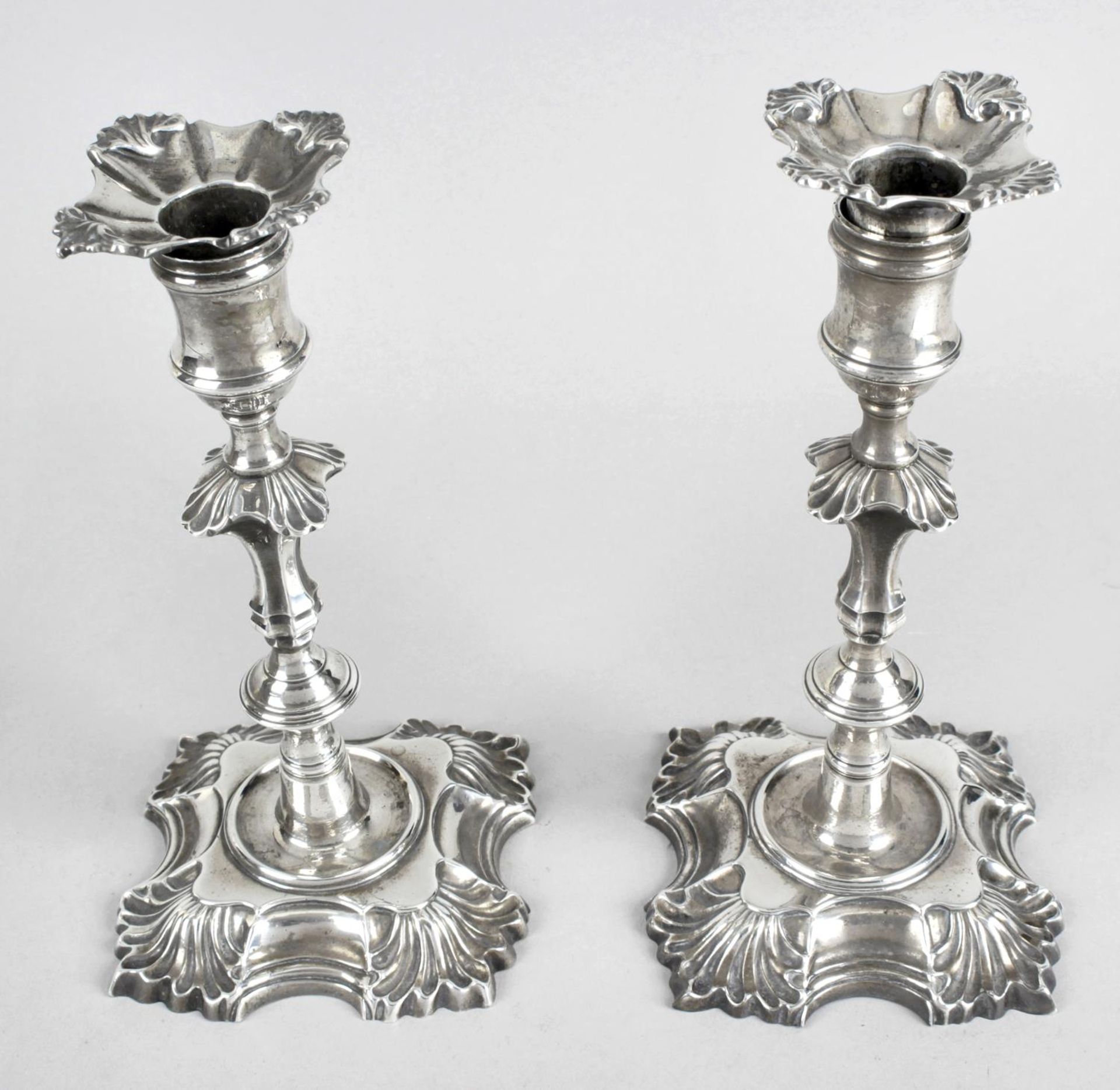 A pair of George II cast silver candlesticks by John Cafe,