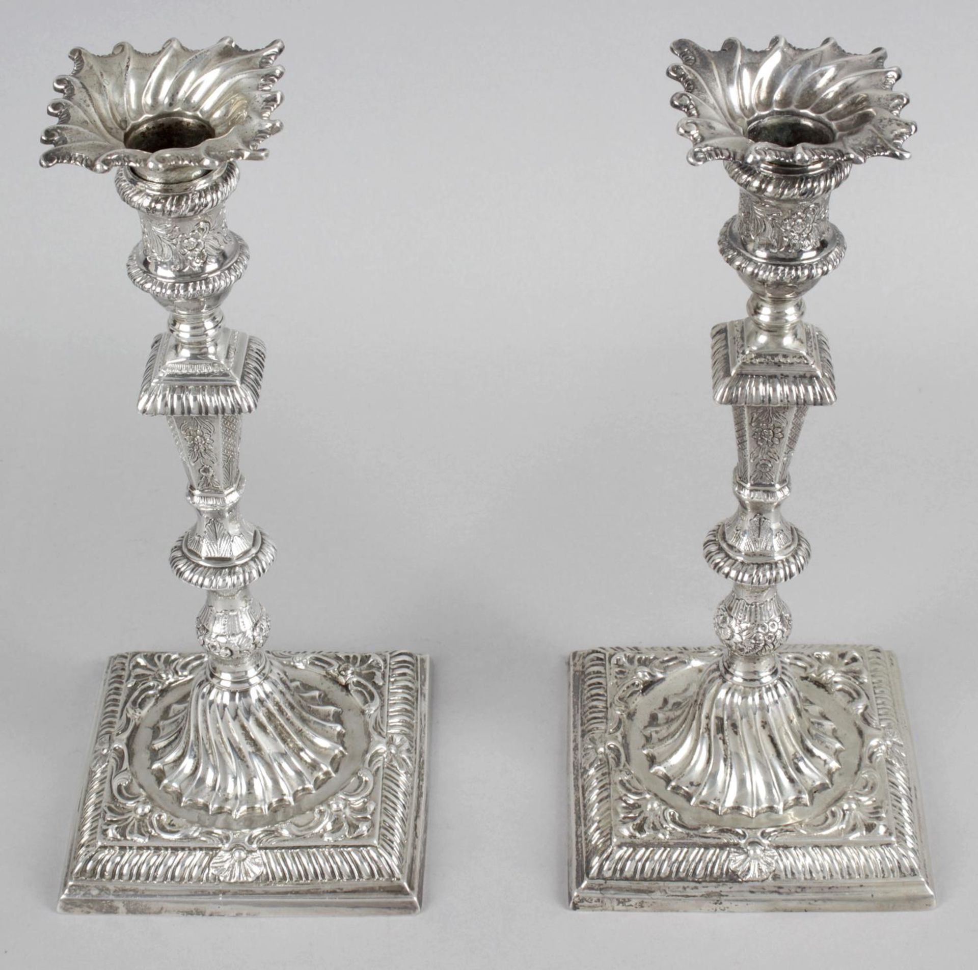 A matched pair of early George III silver candlesticks,