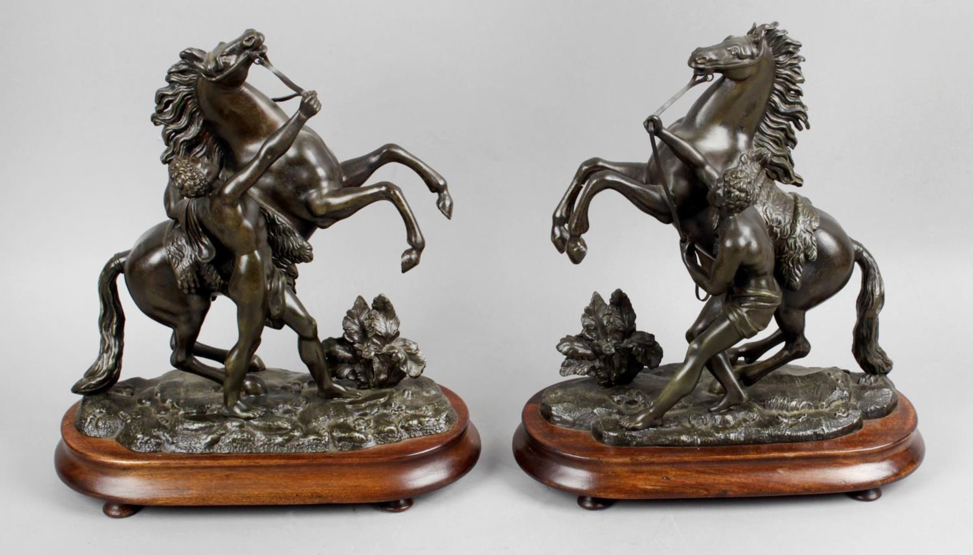 A pair of late 19th century bronzed Marley horsemen,