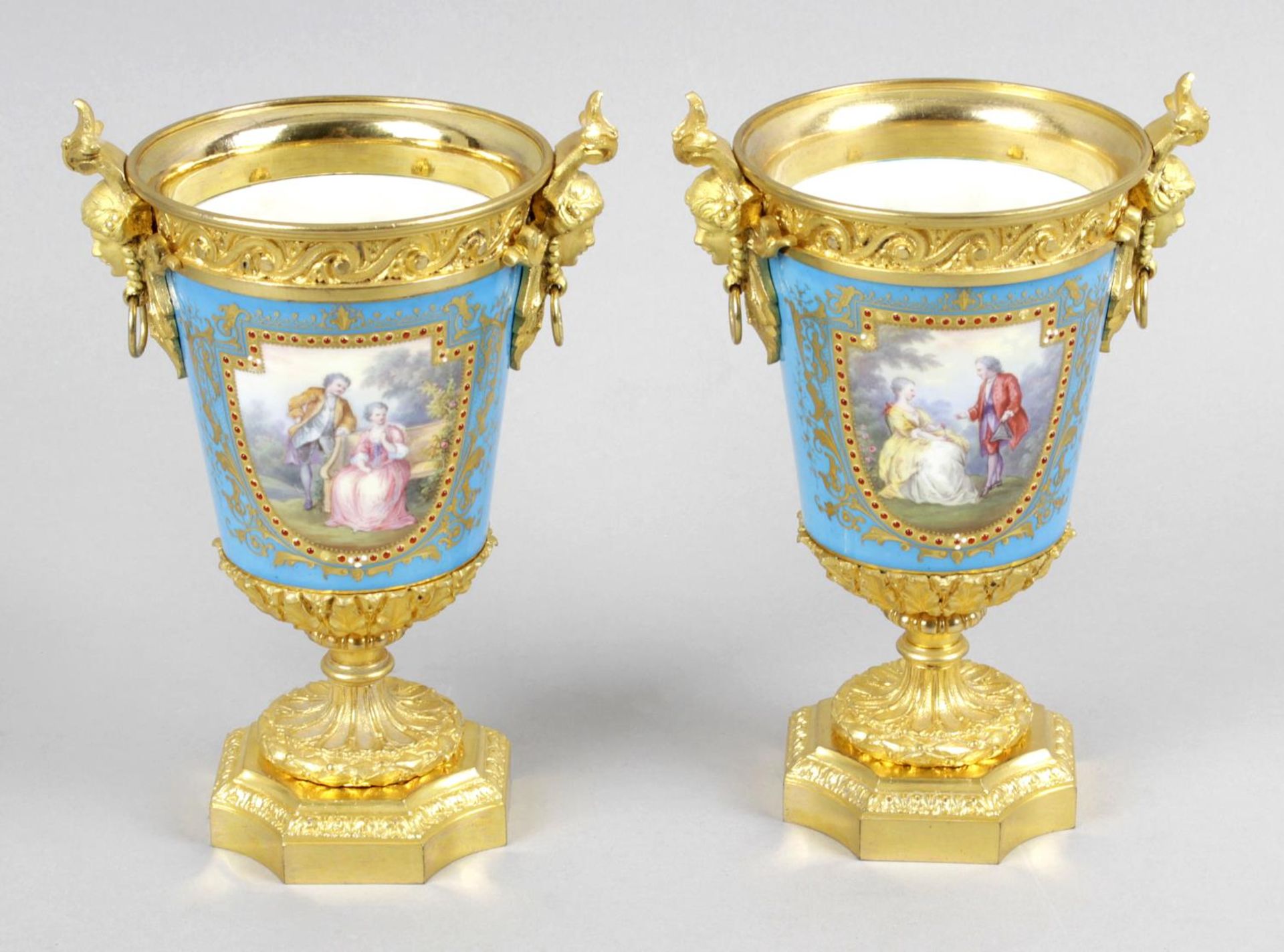 A pair of Sevres style porcelain gilt metal mounted twin handled vases,