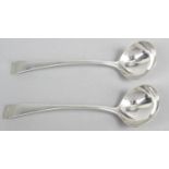 A pair of provincial silver toddy ladles, in Old English pattern with plain circular bowls.