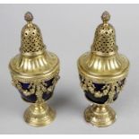 A pair of early 20th century silver-gilt casters,