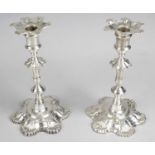 A pair of George II cast silver candlesticks by John Cafe,