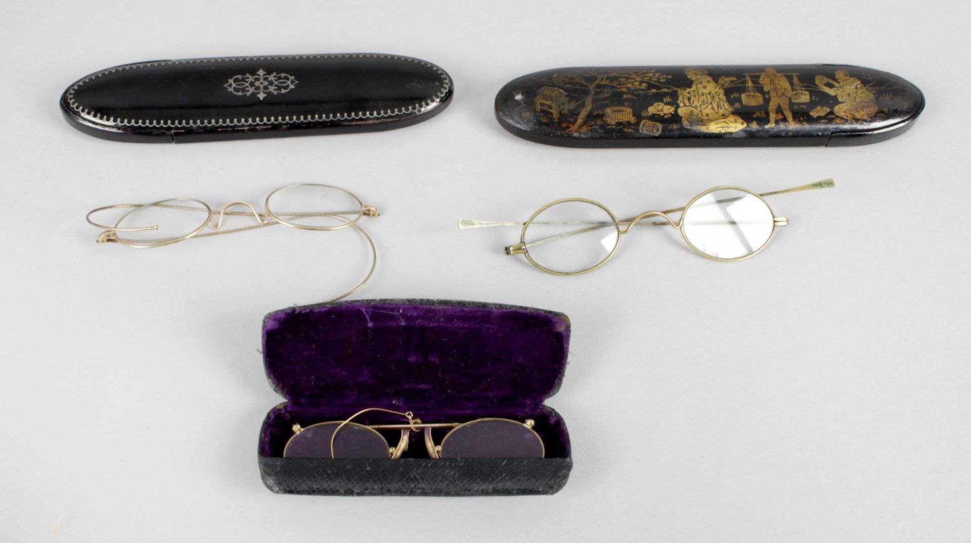 A pair of yellow metal framed pince-nez contained within a hinged fitted case,