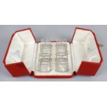 A cased set of four small George V silver toast racks,