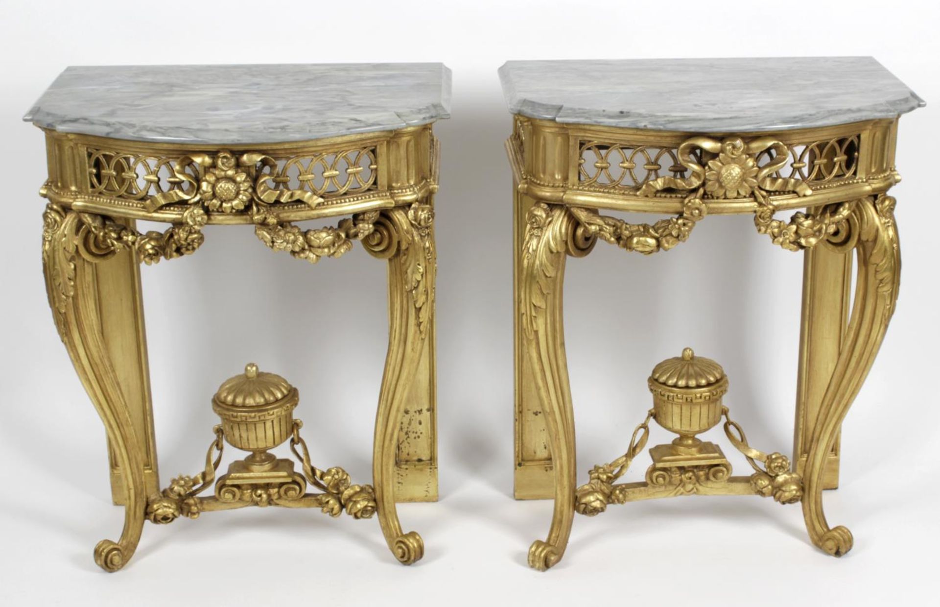 A pair of antique and later carved and moulded giltwood console tables,