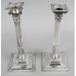 A pair of Irish cast silver candlesticks,