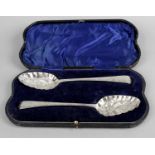 A cased pair of George III silver 'berry' spoons,