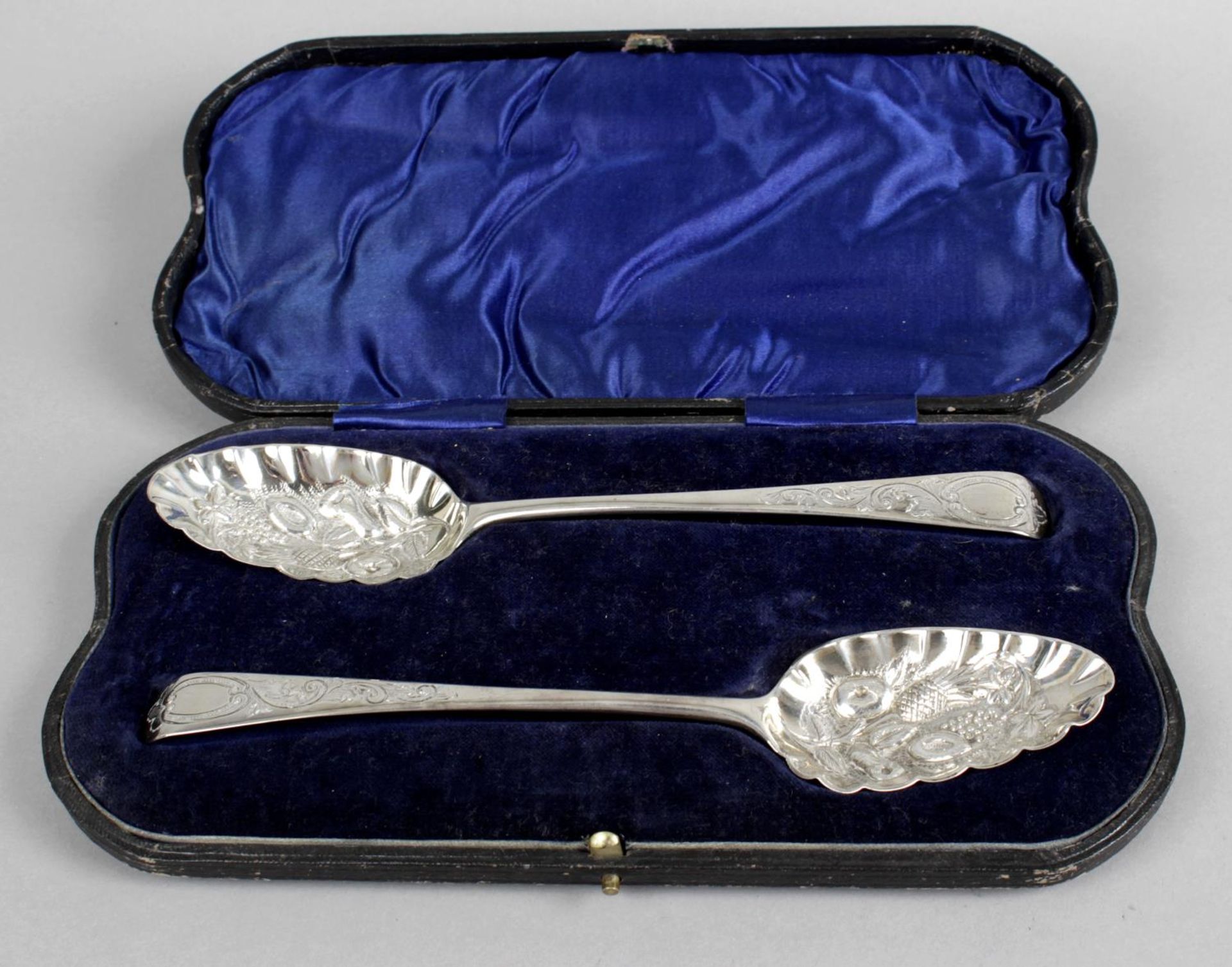 A cased pair of George III silver 'berry' spoons,