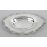 An Edwardian silver oval dish, of plain shallow form with a floral and foliate scroll pierced rim.