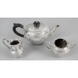 A late Victorian silver three piece bachelor tea service,