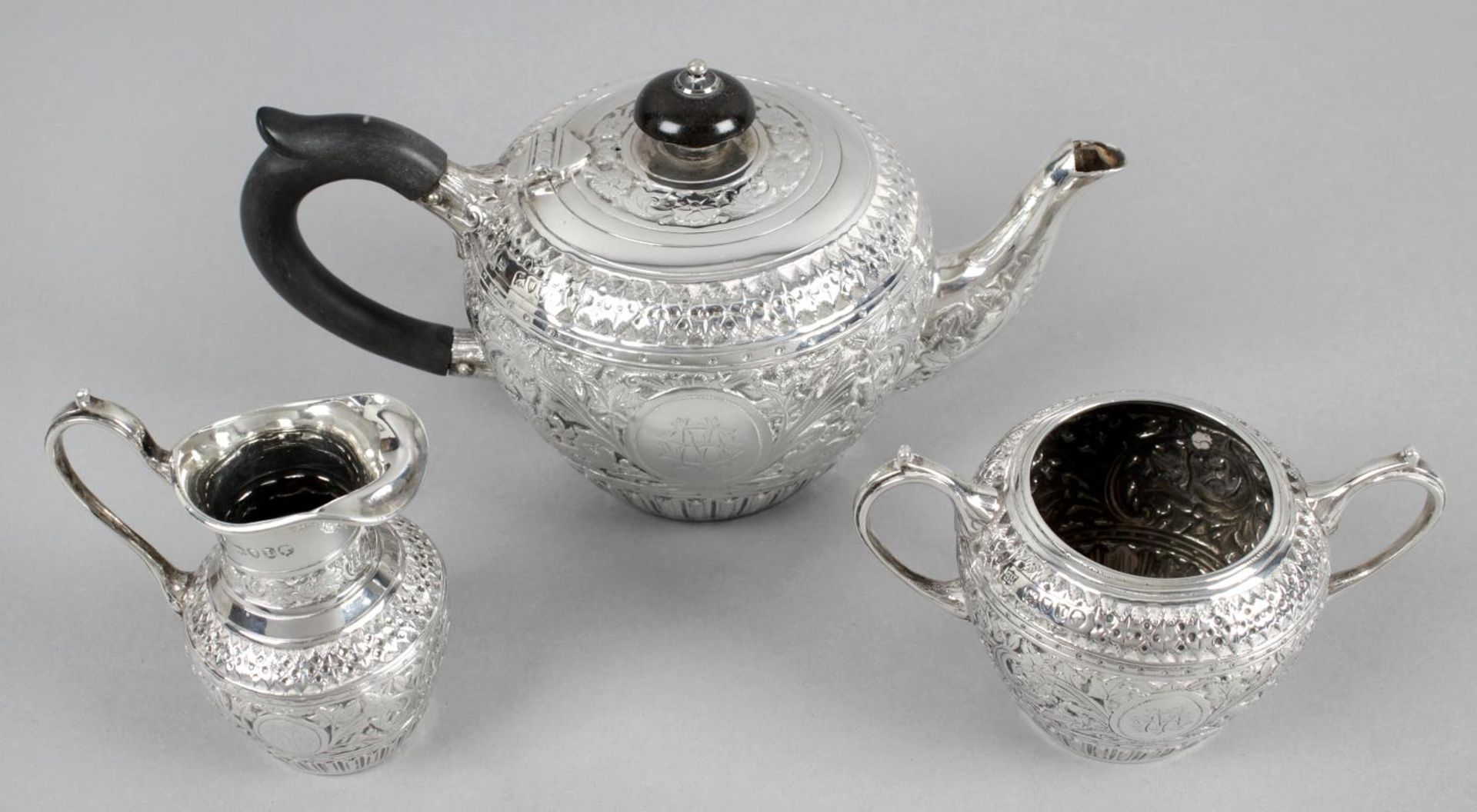 A late Victorian silver three piece bachelor tea service,