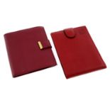 ROLEX - a pair of red leather wallets.