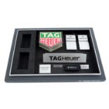 TAG HEUER - a group of assorted watch display signs with a tray.