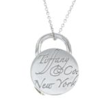 A silver circular lock pendant, with chain, by Tiffany & Co.