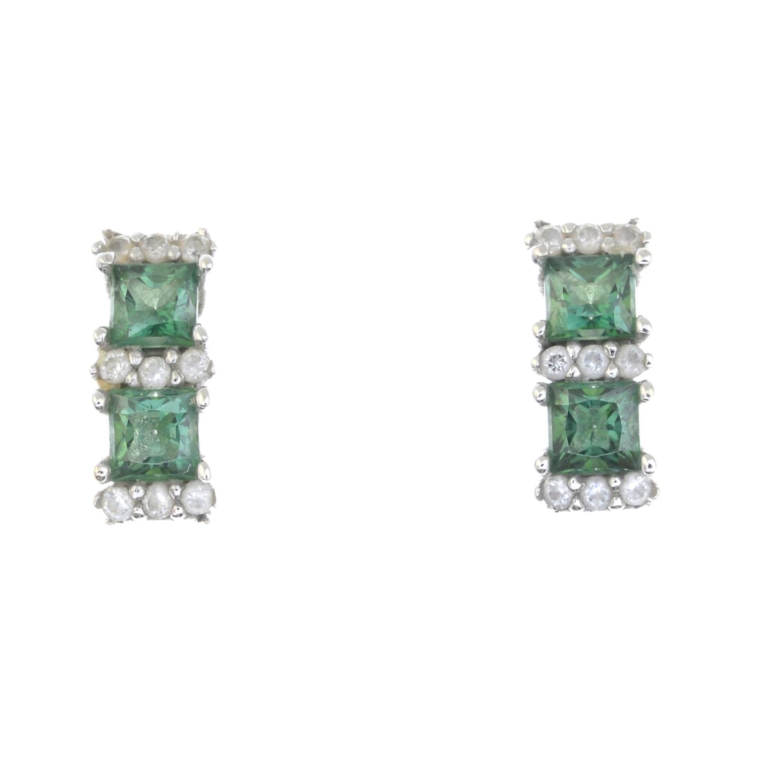 A pair of green cubic zirconia and colourless gem earrings.Green cubic zirconias each with