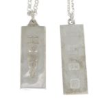 Two silver ingot necklaces.