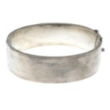A textured hinged bangle.Stamped silver.Inner diameter 6.2cms.
