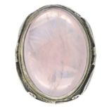 A rose quartz cabochon dress ring.