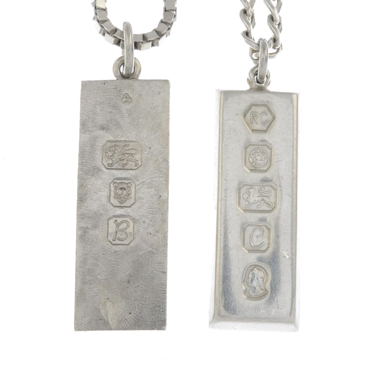 Two silver ingot necklaces.