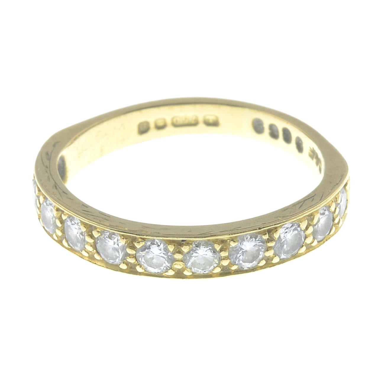 A 18ct gold diamond set half hoop eternity ring.Estimated total diamond weight 0.66ctStamped 750.