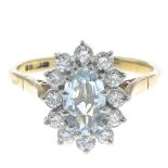 An 18ct gold aquamarine and diamond cluster ring.Estimated total diamond weight 0.50ct.